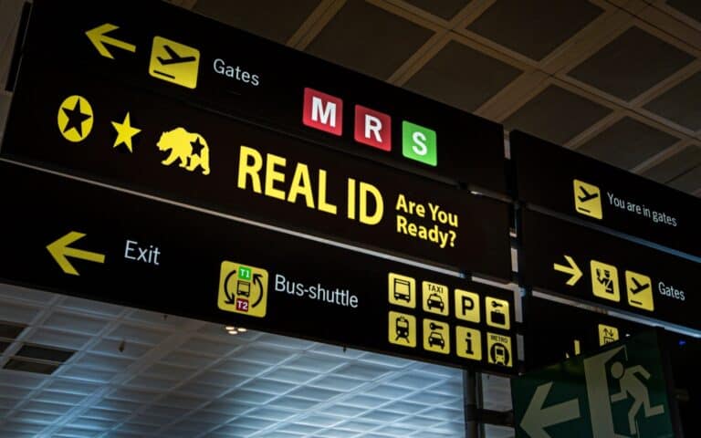 Illuminated airport signage displaying the Real ID compliance, reminding passengers at airport of new travel document requirements.