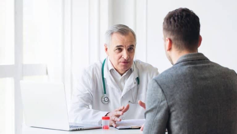 Man speaks with doctor.