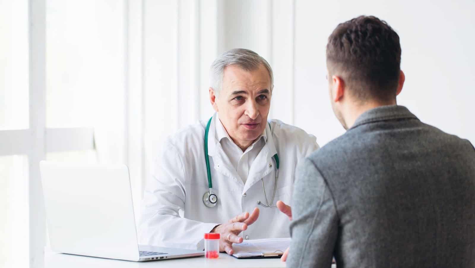 Man speaks with doctor.