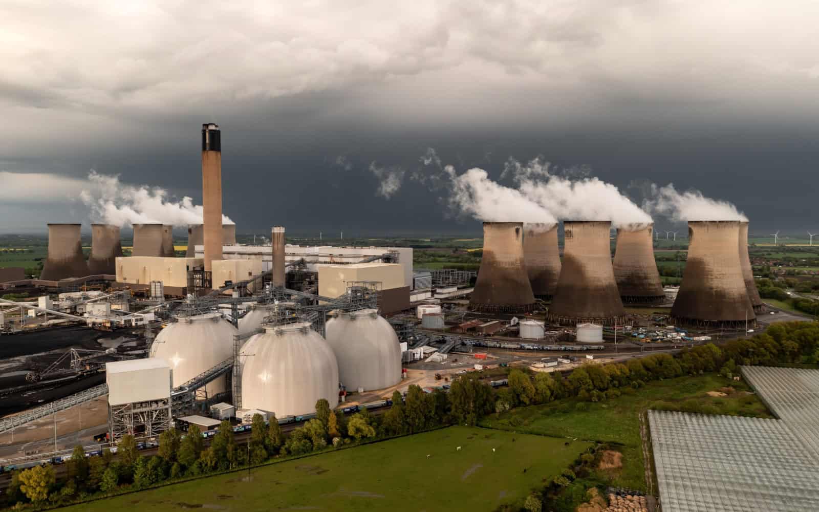 DRAX POWER STATION, SELBY, UK - MAY 5, 2023. Aerial landscape view of Drax Power Station in North Yorkshire burning coal with CO2 emissions and Biomass storage tanks for net zero output