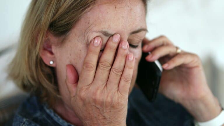 senior woman on phone upset.