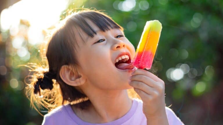 child with popsicle.