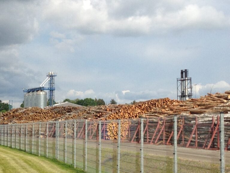 Log yard and silos at Osula Graanul Invest pellet mill in Sõmerpalu, Võru County, Estonia, July 2019. Credit: Peg Putt