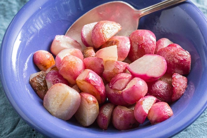 sauteed-radishes-in-a-blue-bolw-with-a-silver-spoon.