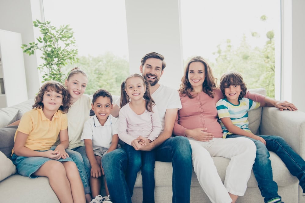 Dream, dreamy, leisure, lifestyle sister brother concept. Portrait of positivity, glad, enjoy, rejoice large family many children rest and relax on sofa in living room look at camera and smile