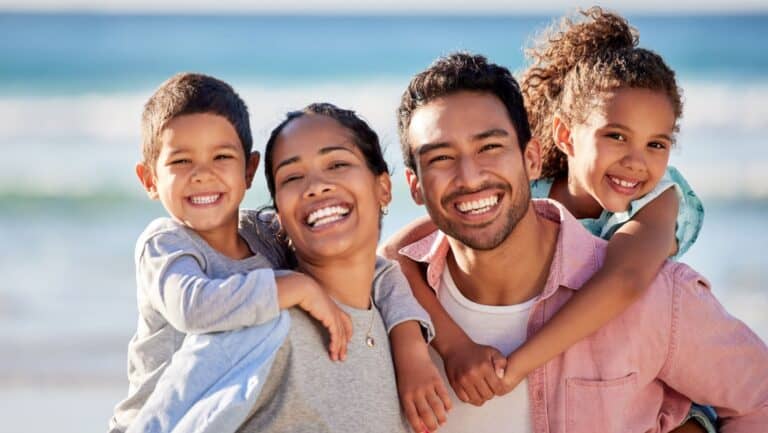 smiling family at beach.