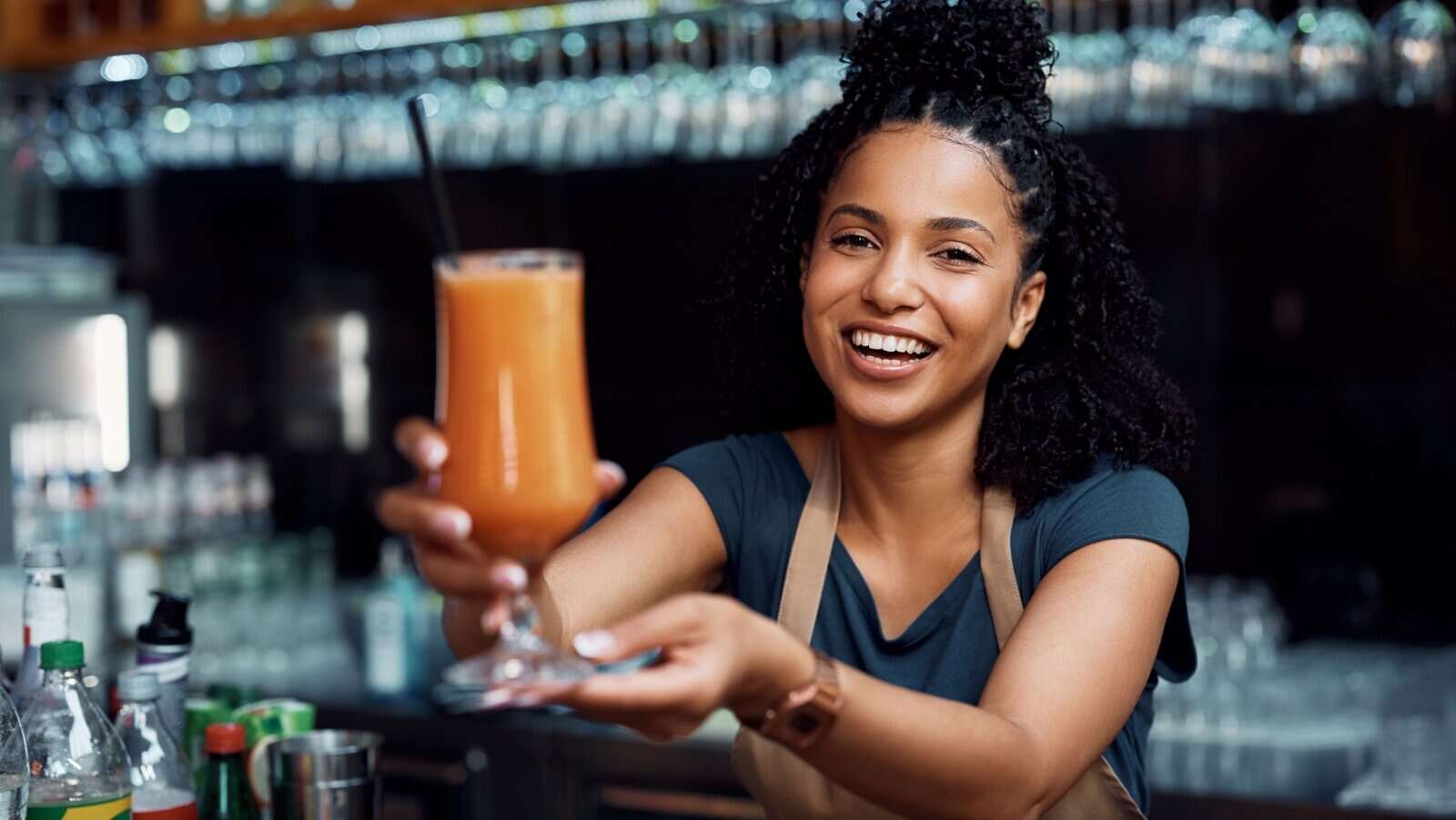 woman serving beverage. drink. bartender.