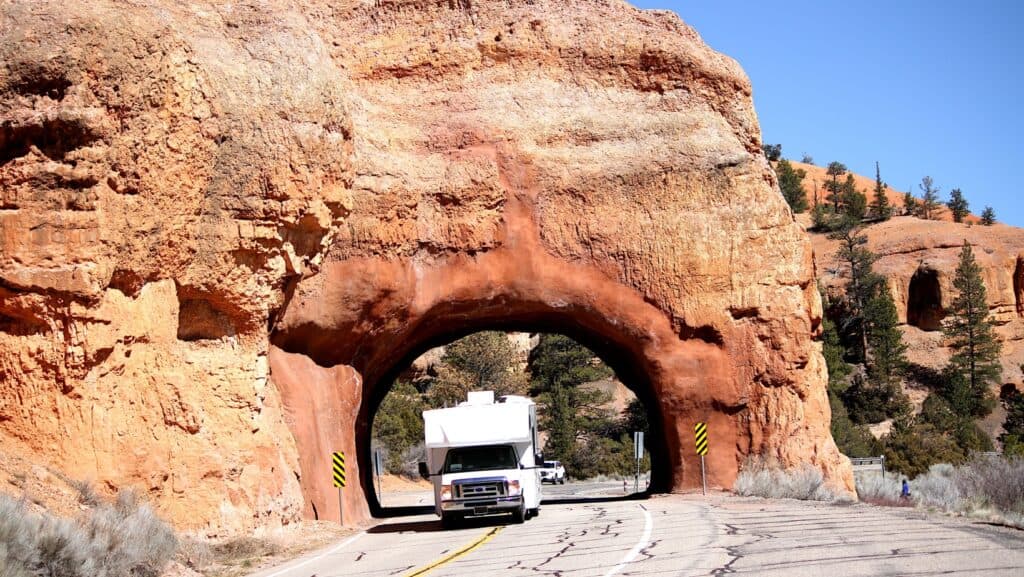 Class C RV driving on road. 