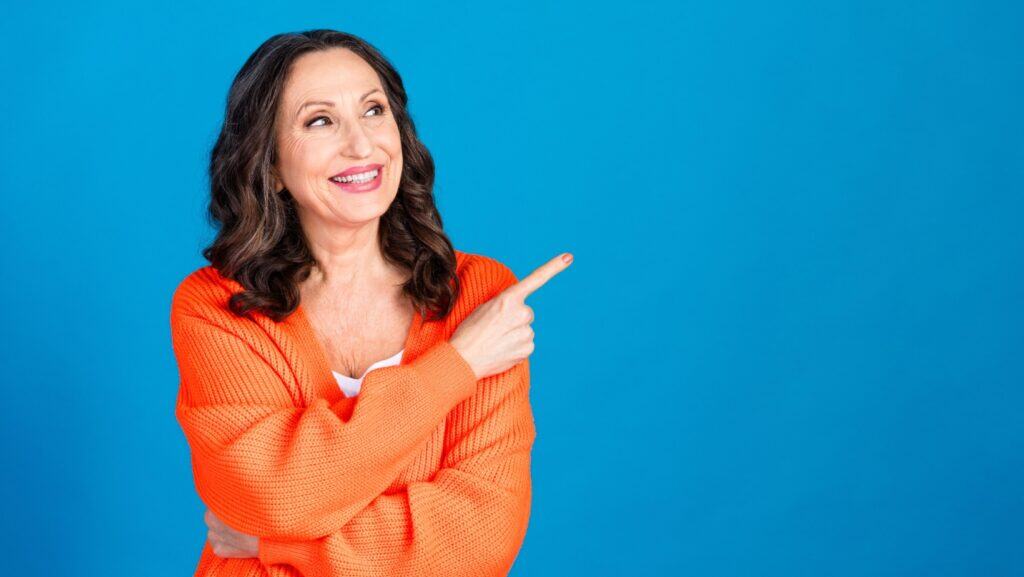happy senior woman pointing finger. This. Agree.