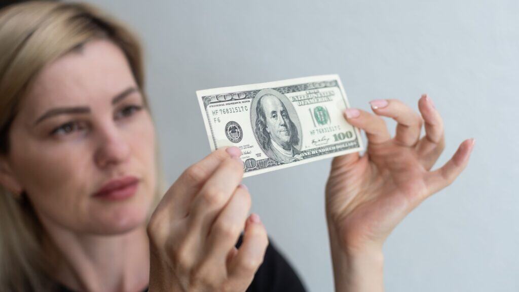 woman looking at money.