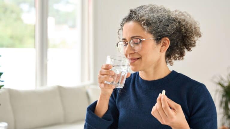 woman taking pill.