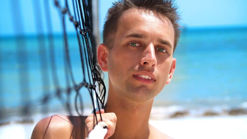 Man with volleyball net. 