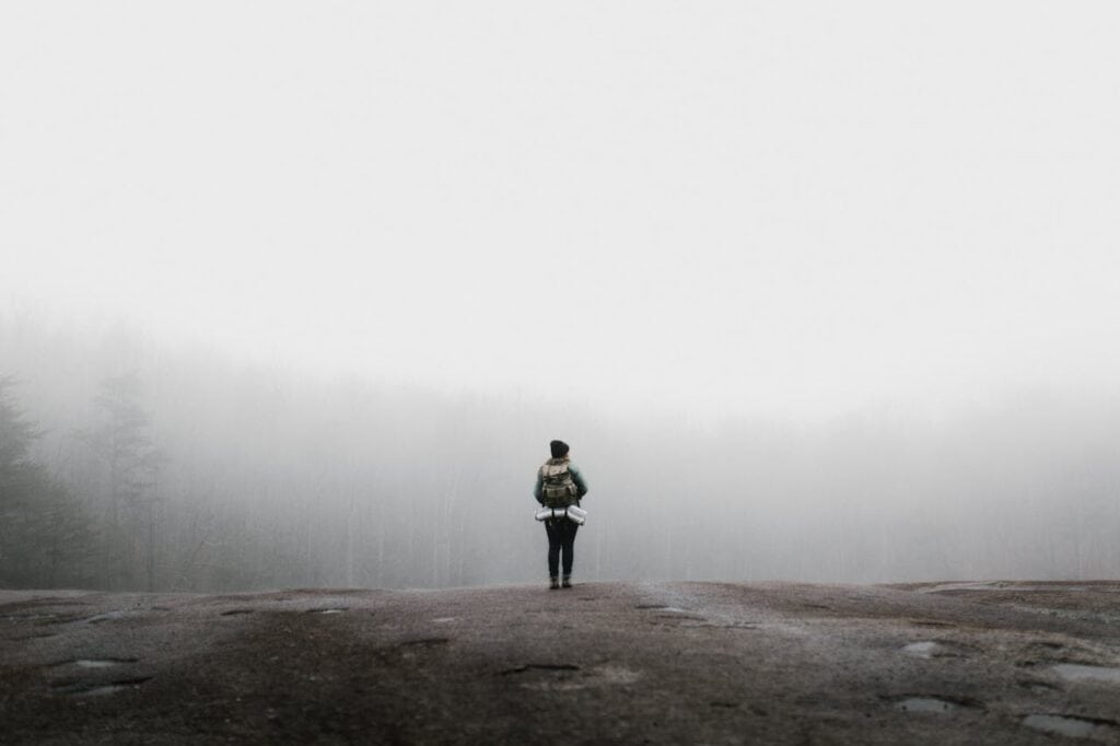 woman in fog on mountain.