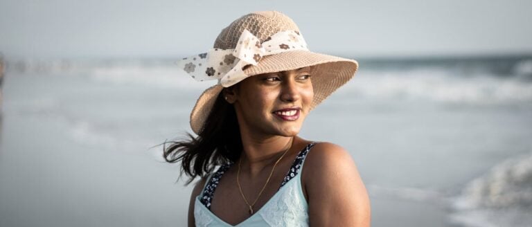 woman in hat on beach.