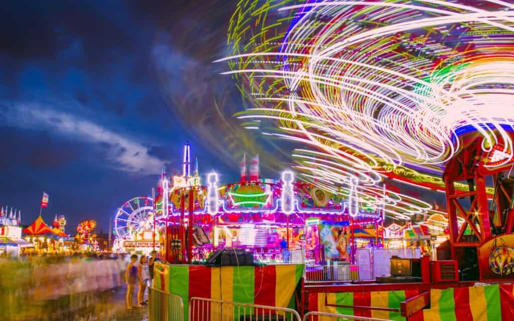 ST. PAUL, MN - SEPTEMBER 2015 - A Wide Angle Long Exposure Shot of Amusement Park Rides Blurring during a Beautiful Twilight at the Exciting Minnesota State Fair