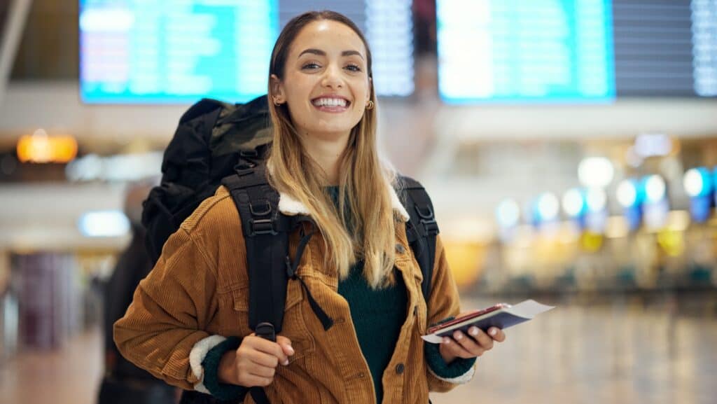 Happy woman in airport.