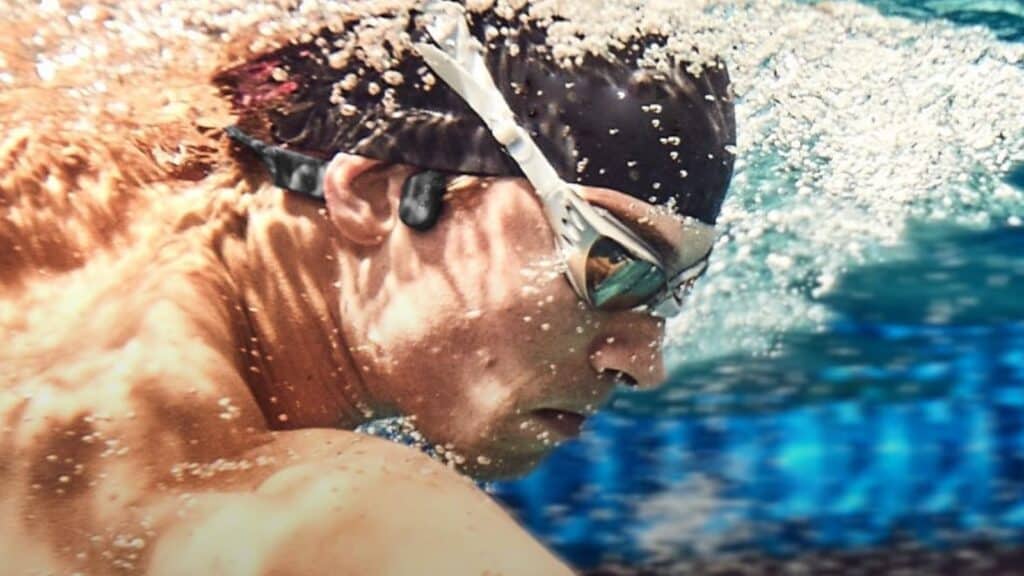 man swimming earbuds