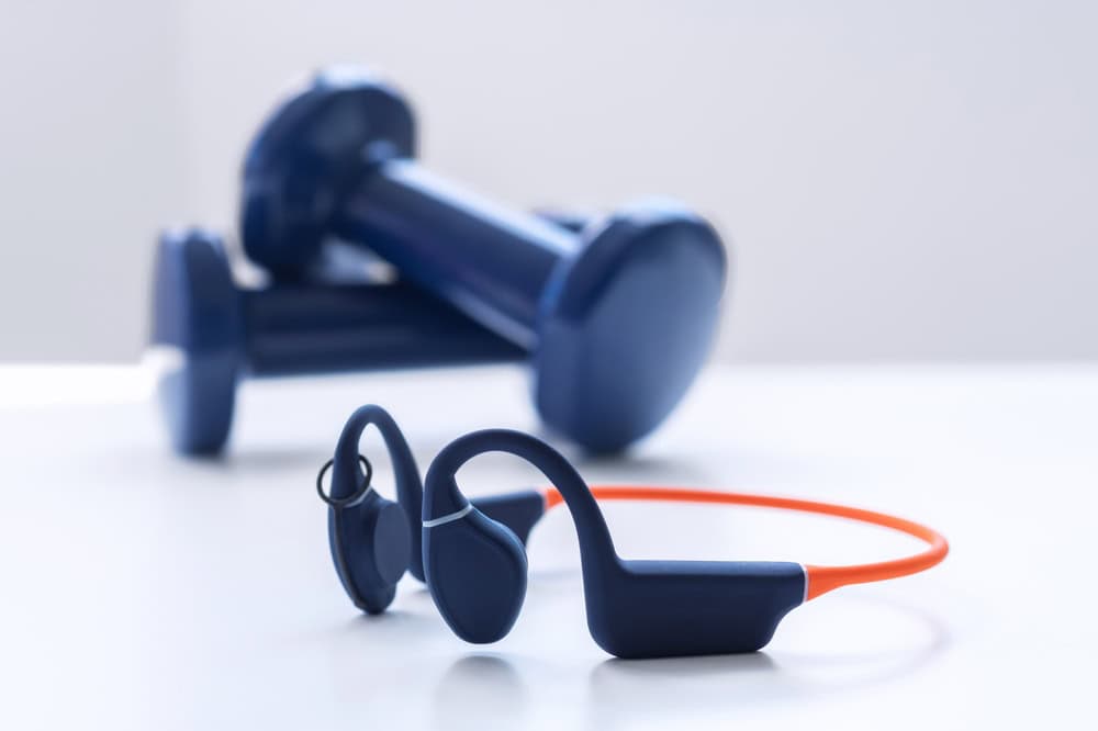 Wireless,Waterproof,Bone,Conduction,Headphones,With,Weights,On,A,White