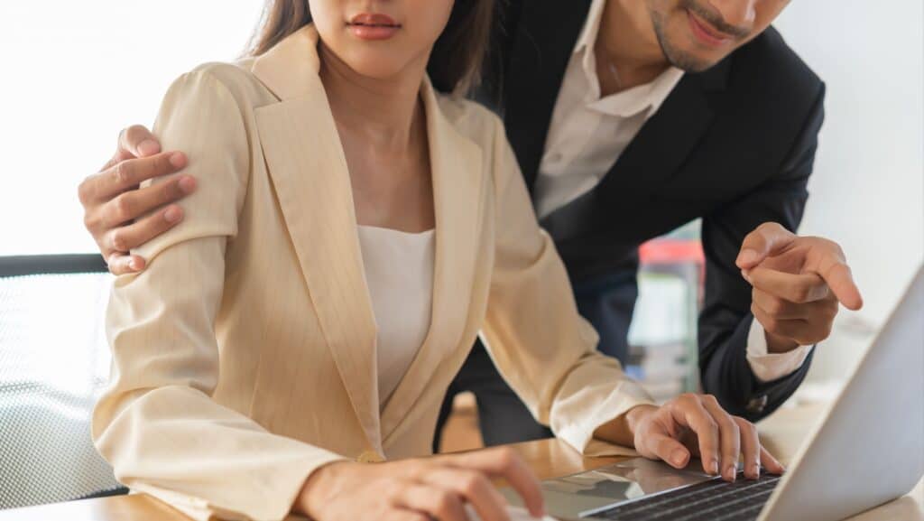 woman at work with rude man. Mansplaning.