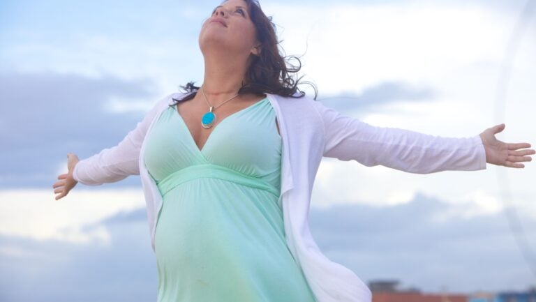 woman outside. Is she pregnant?