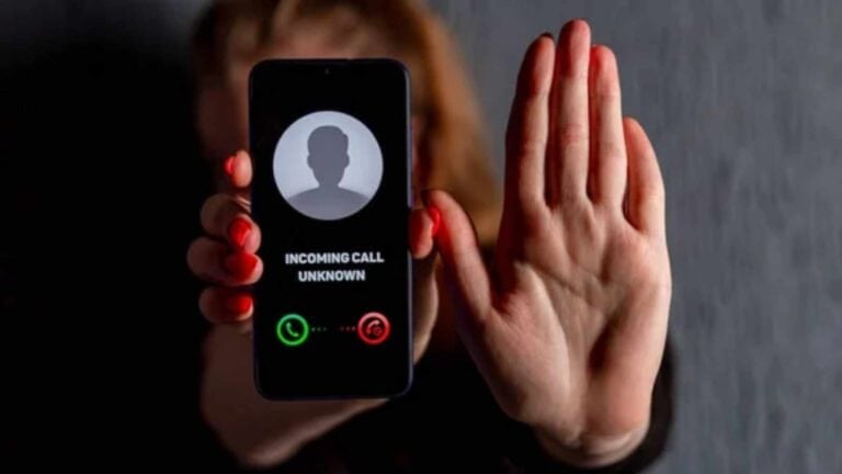 Missed call on smartphone with a raised hand in the background, digital phone, incoming call, spam or unknown caller, phone security and privacy, The Queen Zone.