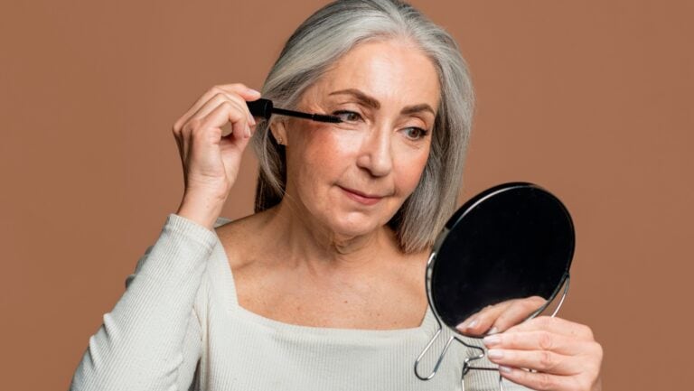 Applying mascara.