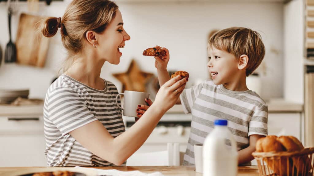 Woman and child feeding bread.