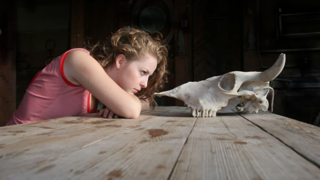 Woman stares at fossil.