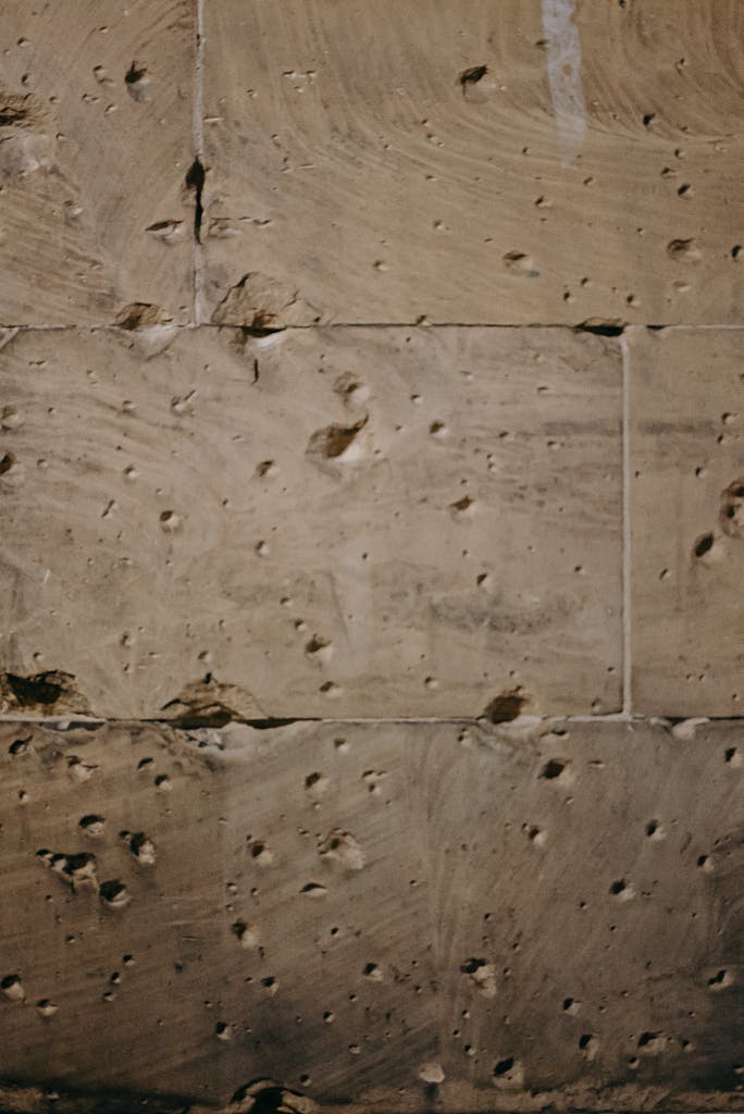 Close-up of a historic wall with bullet marks in Berlin, symbolizing past wars.