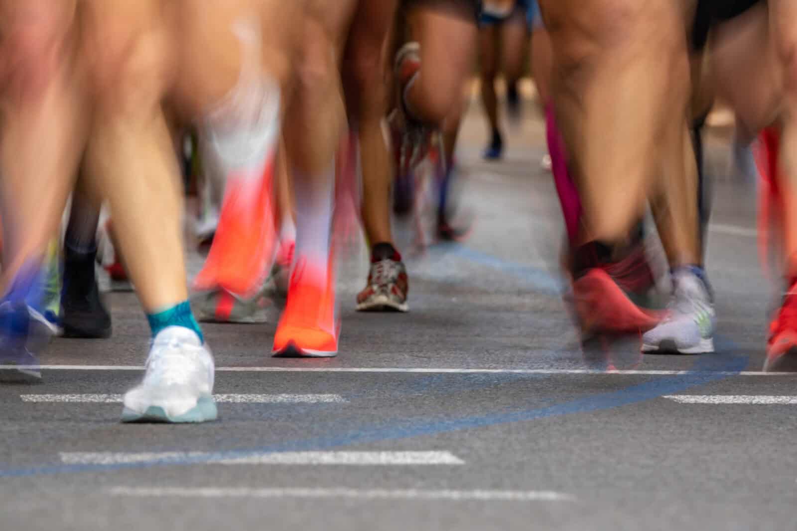 Front view blurred motion of many runner legs