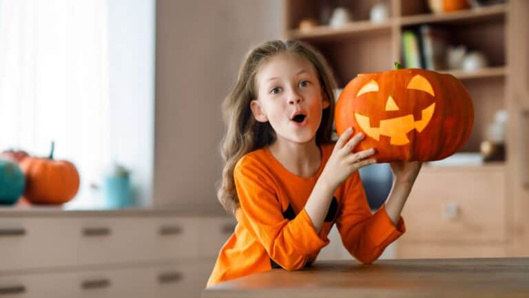 kid with pumpkin.