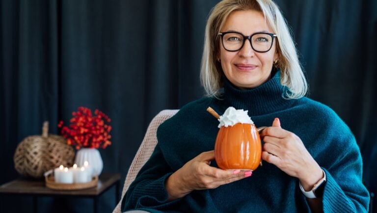 woman with hot pumpkin beverage.