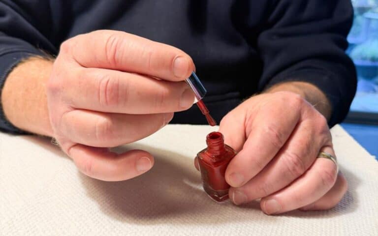 Damon applying nail polish.