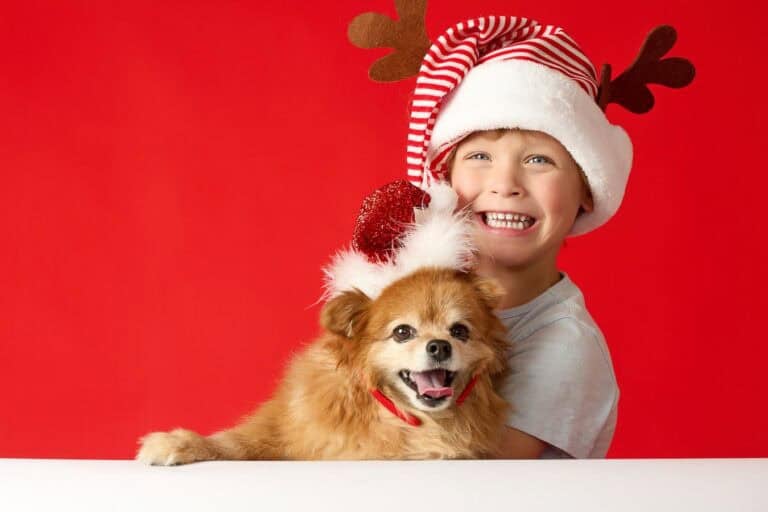 Look at how happy this boy is with his dog at the holidays.