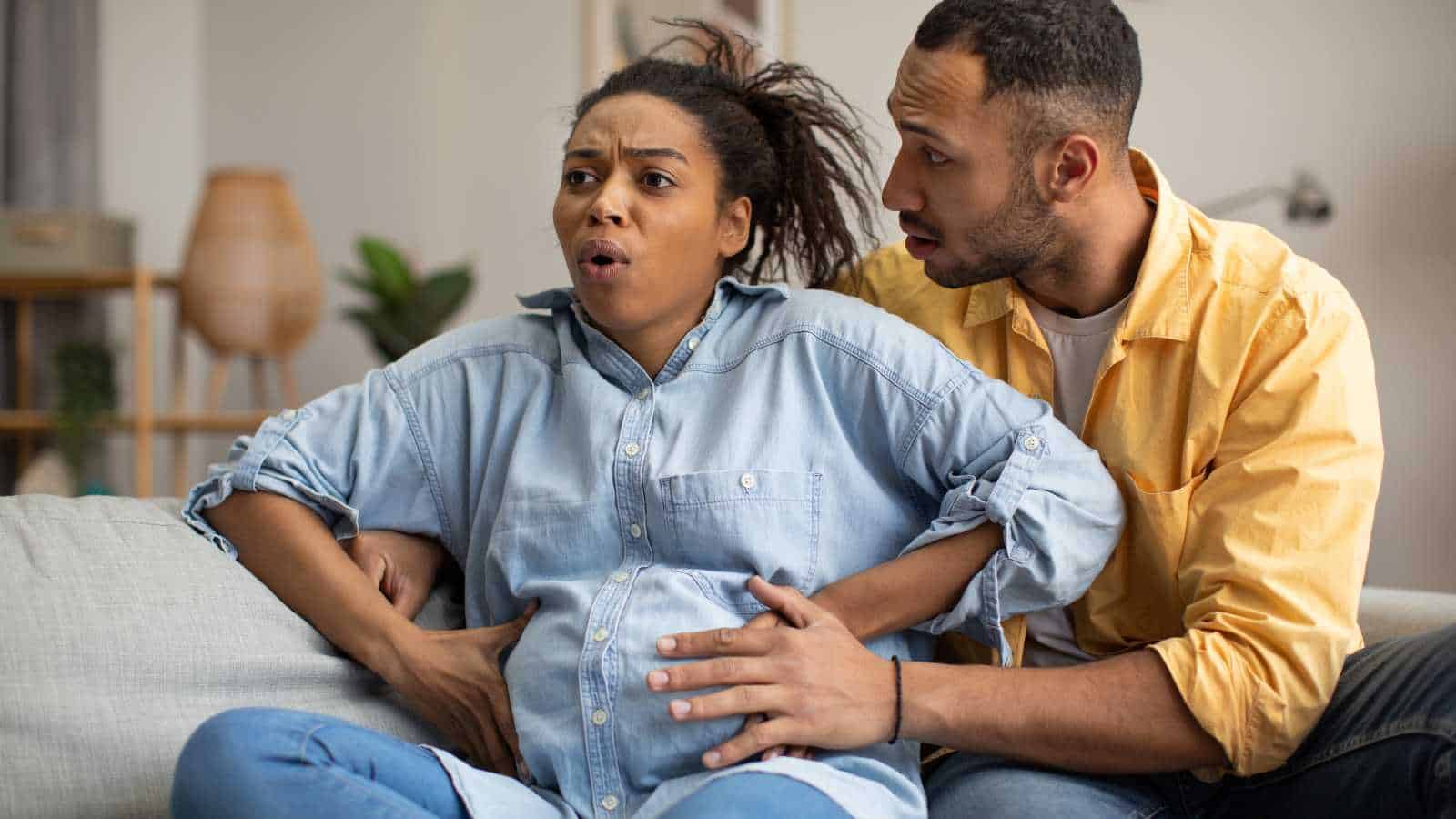 Man Supporting Woman While She's Giving Birth