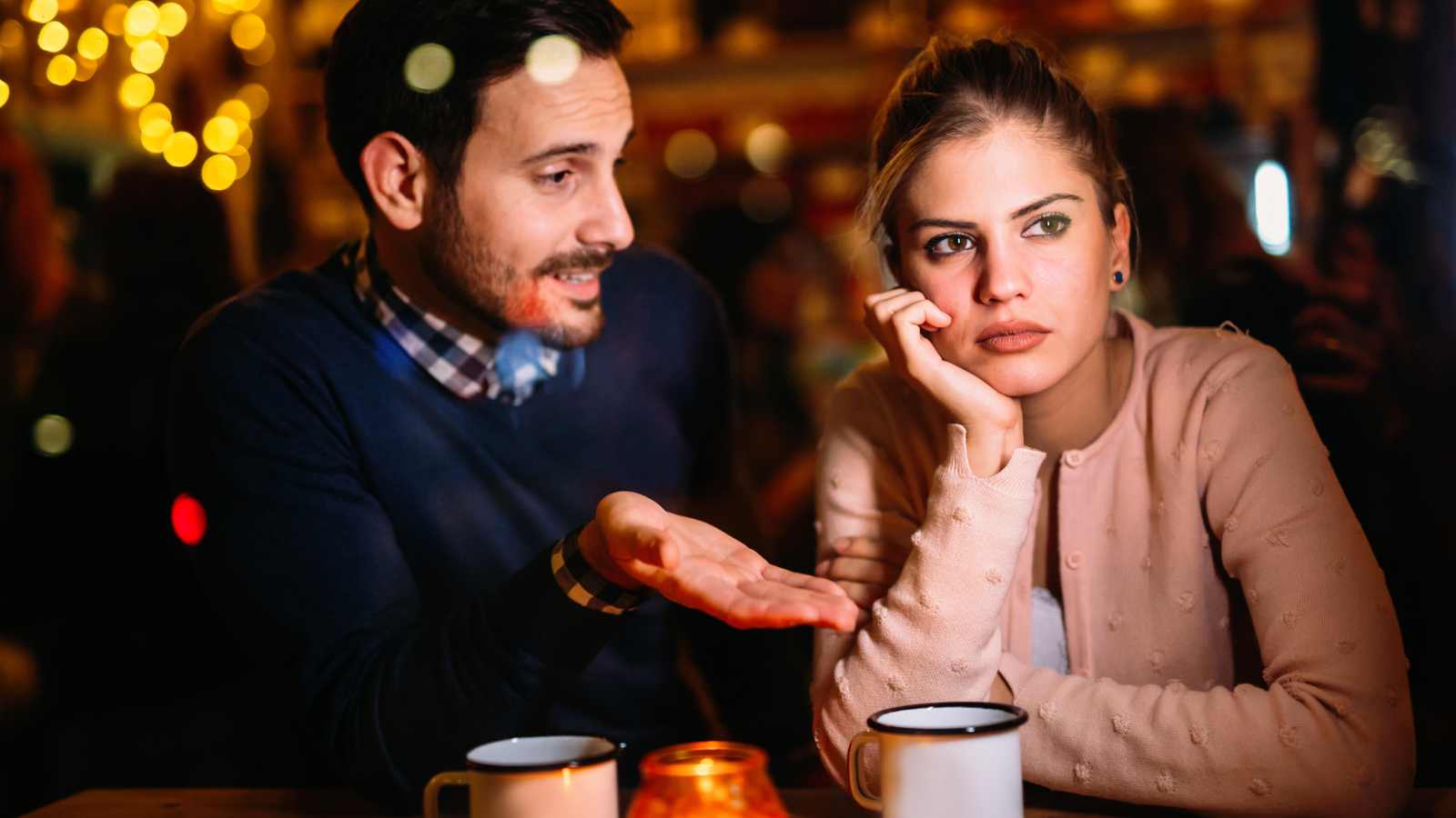 Man talking to an uninterested woman