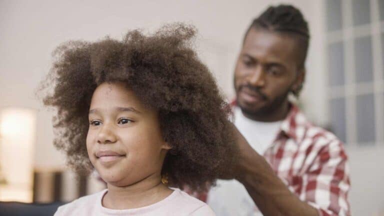 A black girl's hair being done