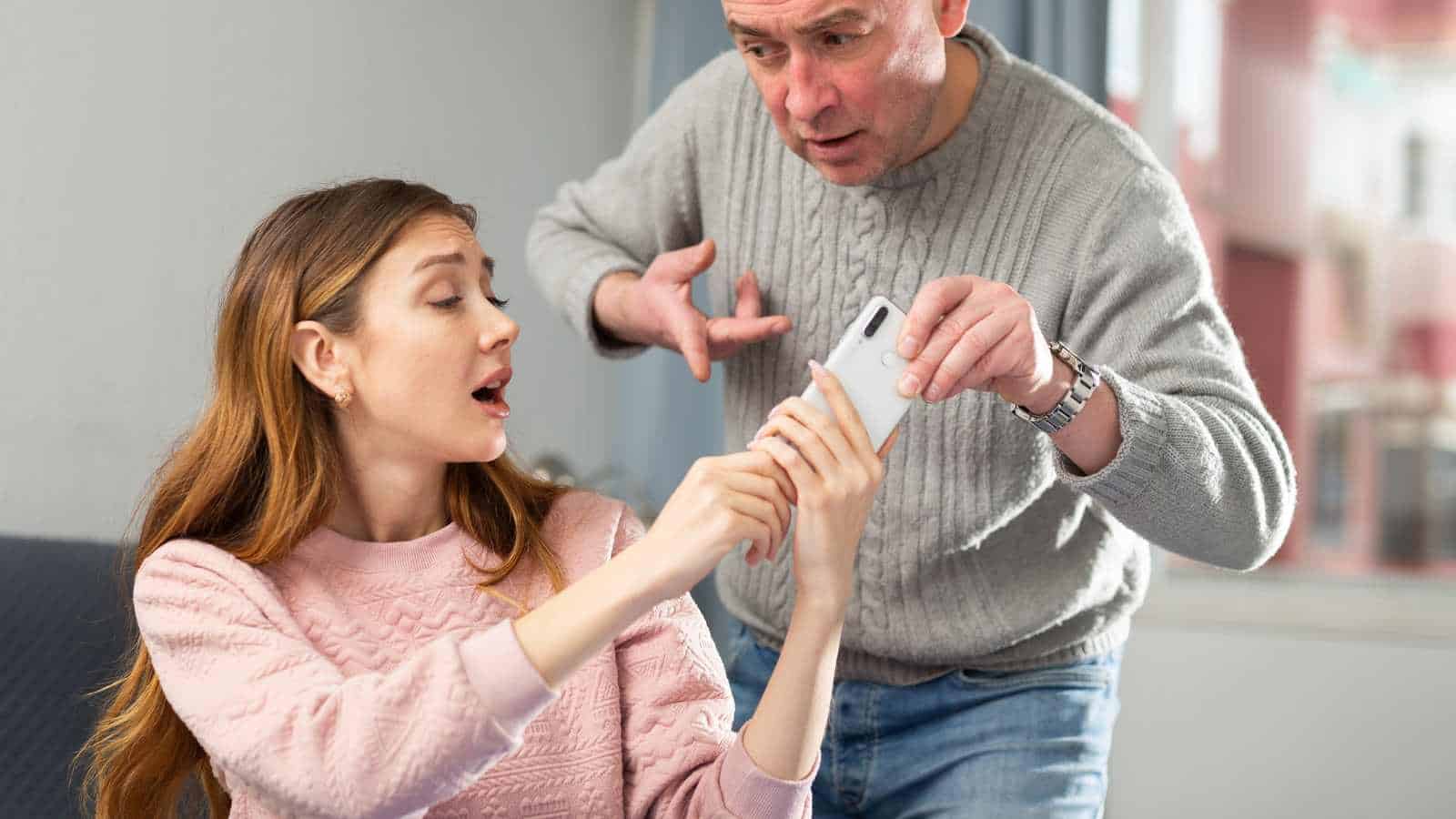 Man taking phone from partner