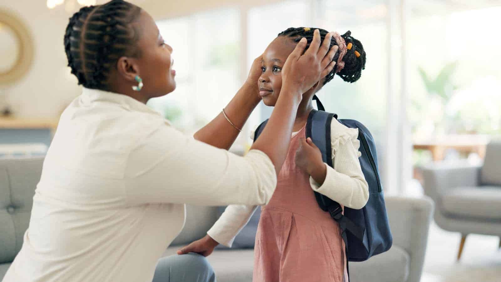 Parent preparing her black daughter