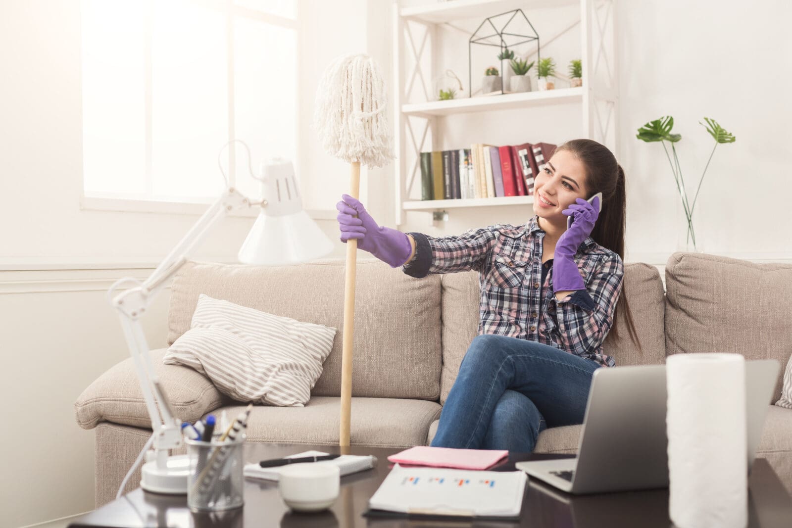 Young,Maid,Talking,On,Phone,During,Cleaning.,Woman,With,Mop