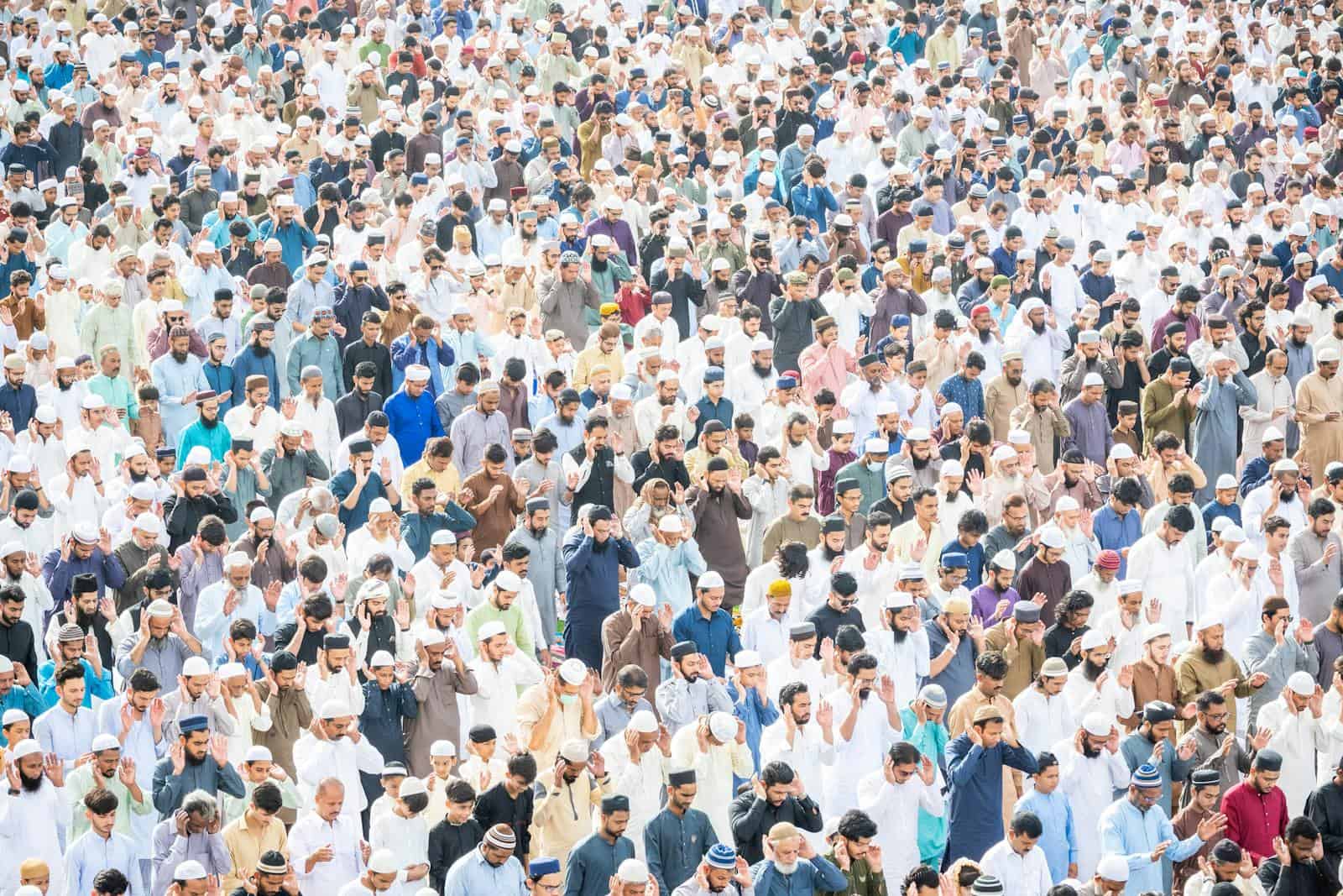Thousands gather in unity for outdoor Islamic prayer service.