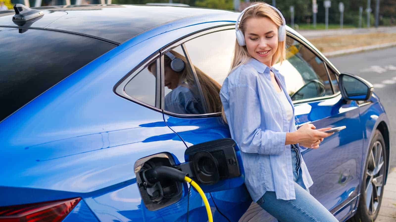 Woman patiently waiting for her EV to charge
