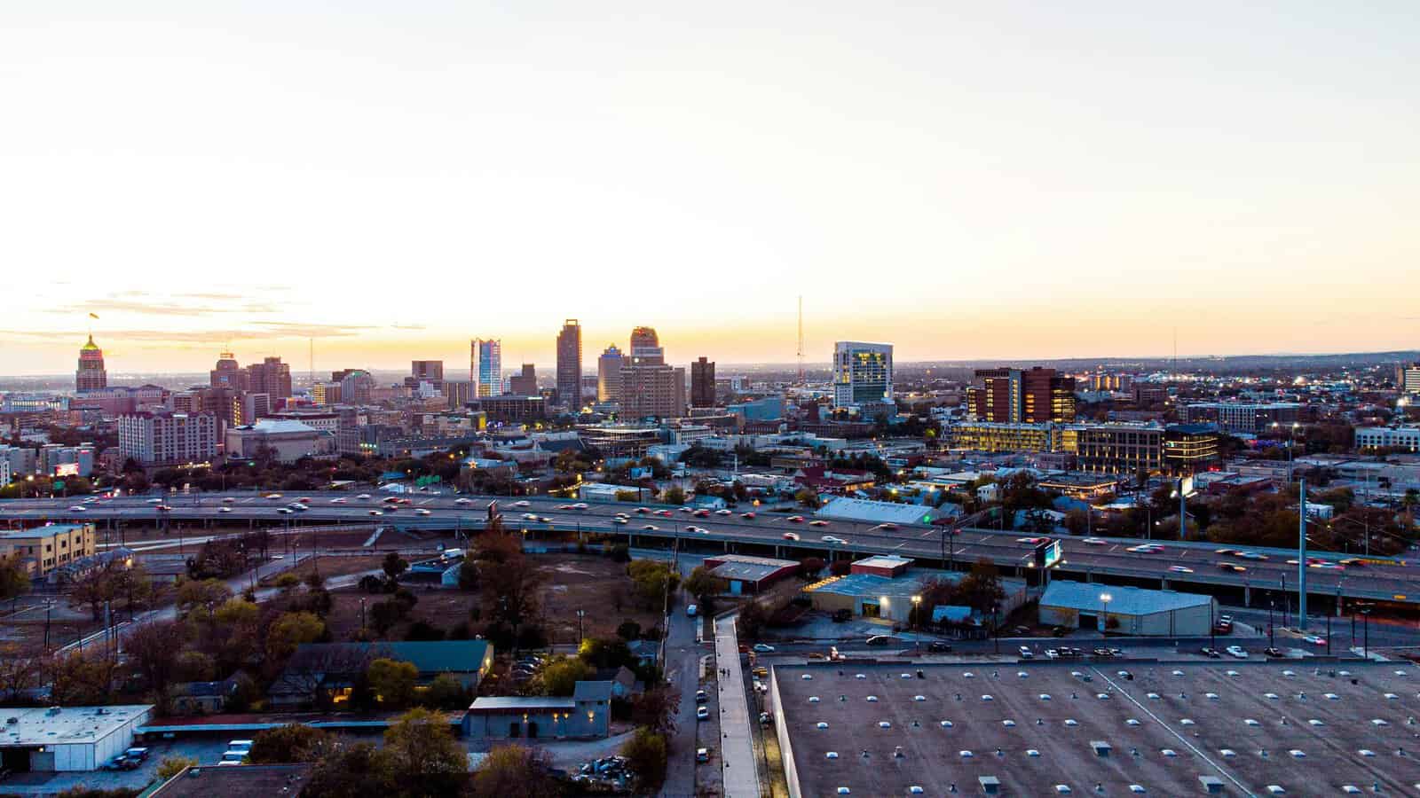 A breathtaking aerial view of San Antonio, texas skyline during sunset, showcasing its urban charm and high-rise buildings.