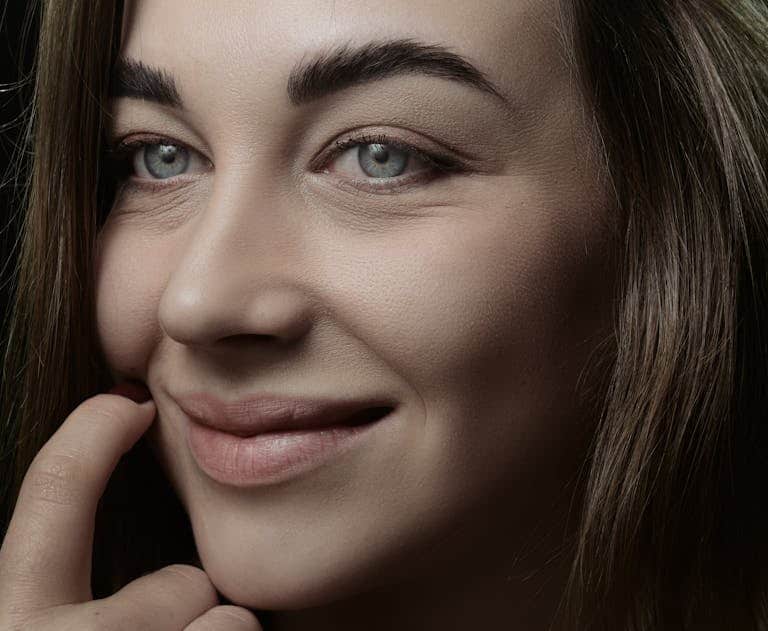 A close-up shot of a woman with a gentle smile and thoughtful expression.