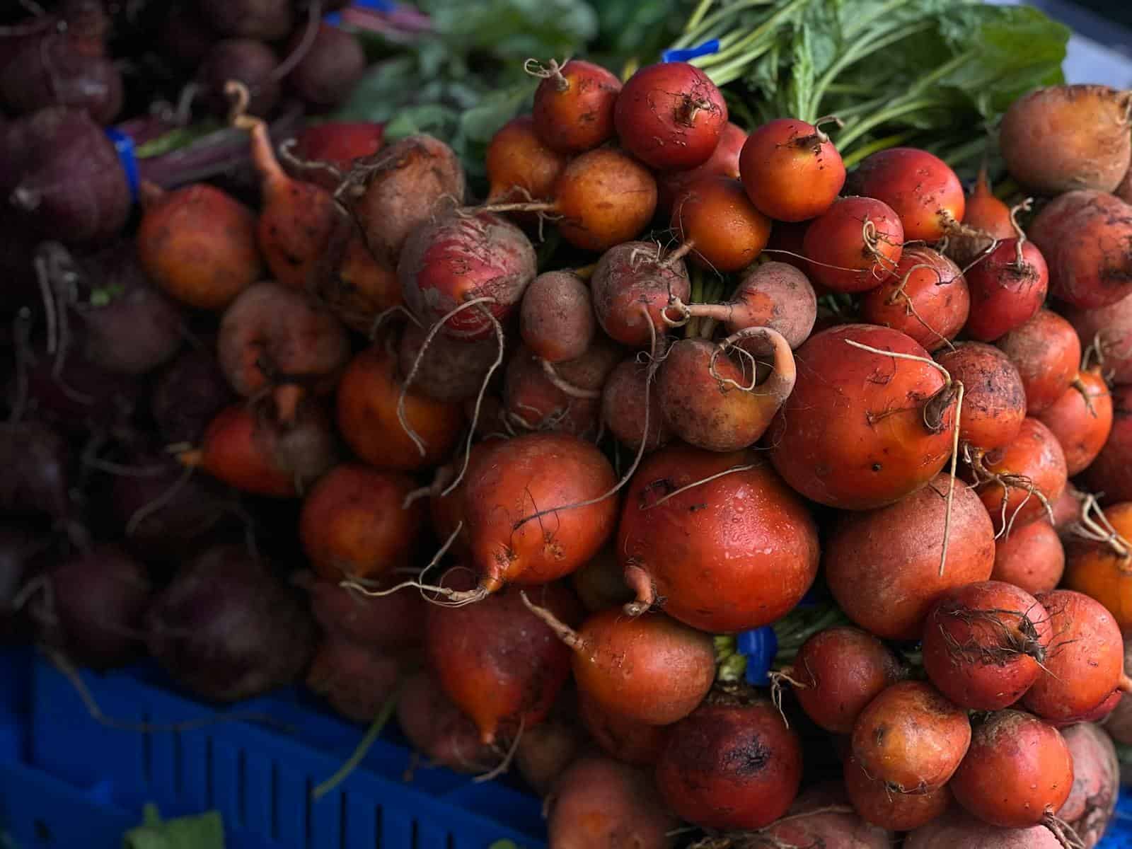 A vibrant display of freshly harvested beets at a market, perfect for healthy eating. Red Beets