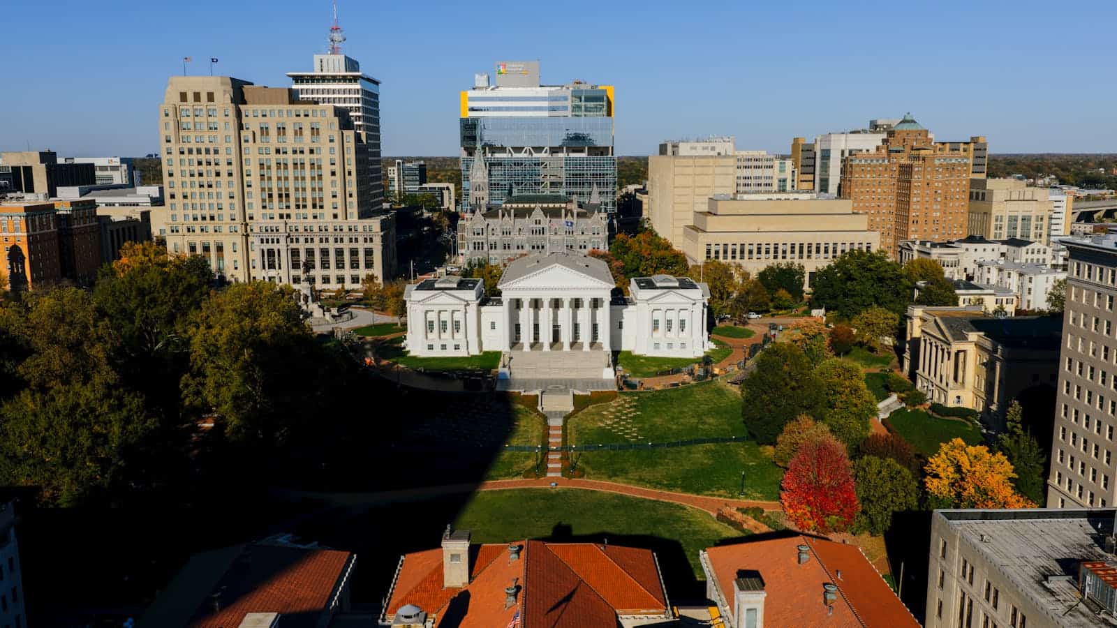 Aerial view of the Virginia State Capitol building surrounded by downtown Richmond, showcasing autumn colors.
