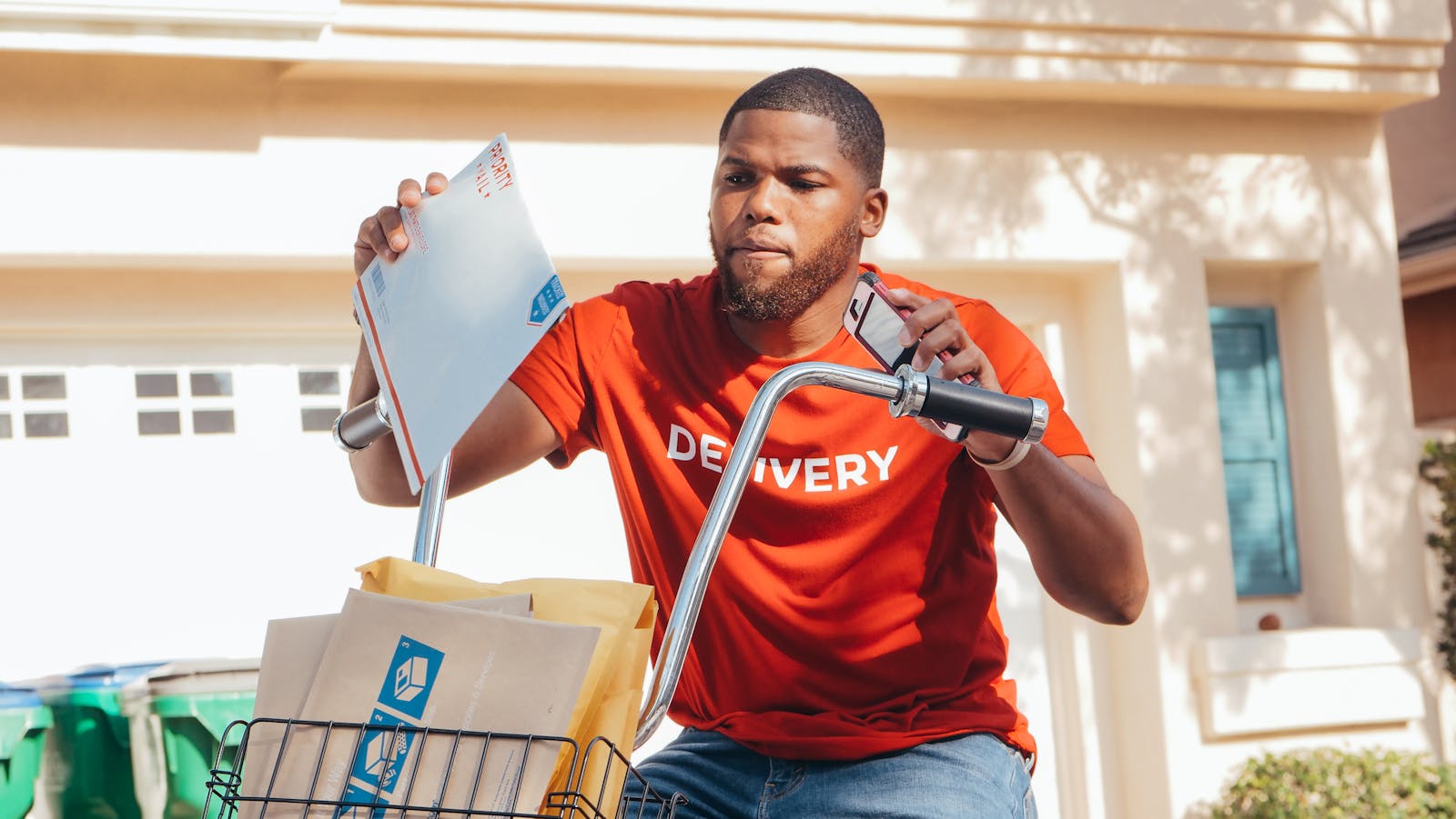 African American man delivering mail on a bicycle outdoors.