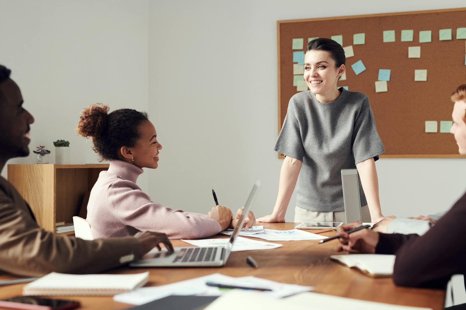 Business team collaborating in a modern office setting with diverse colleagues.