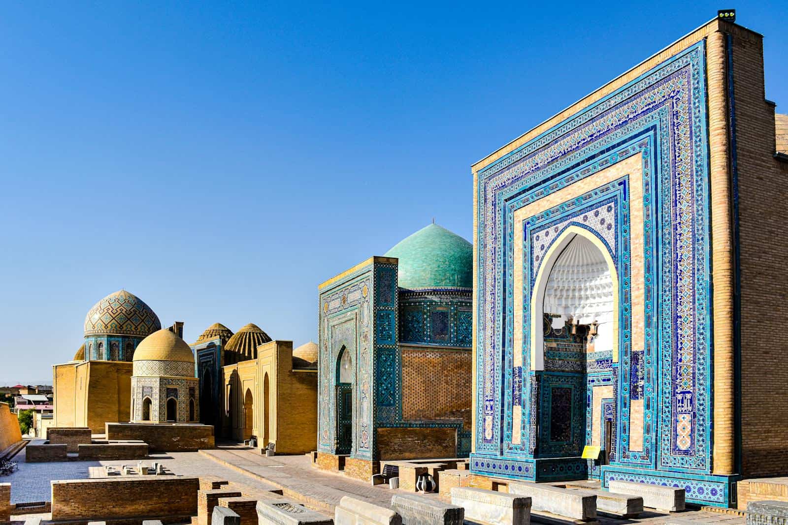 Explore the vibrant mosaics and historic domes of the Shah-i-Zinda complex in Samarkand, Uzbekistan.