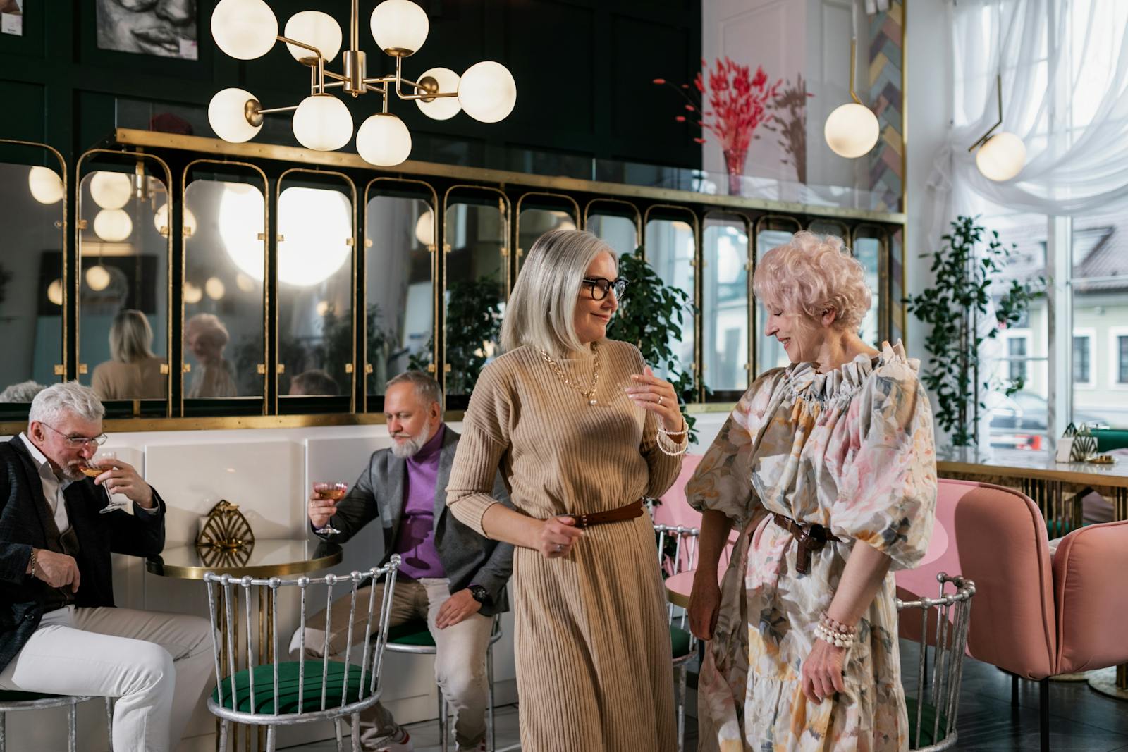 Senior adults enjoying a lively gathering in a stylish indoor cafe setting, celebrating togetherness.